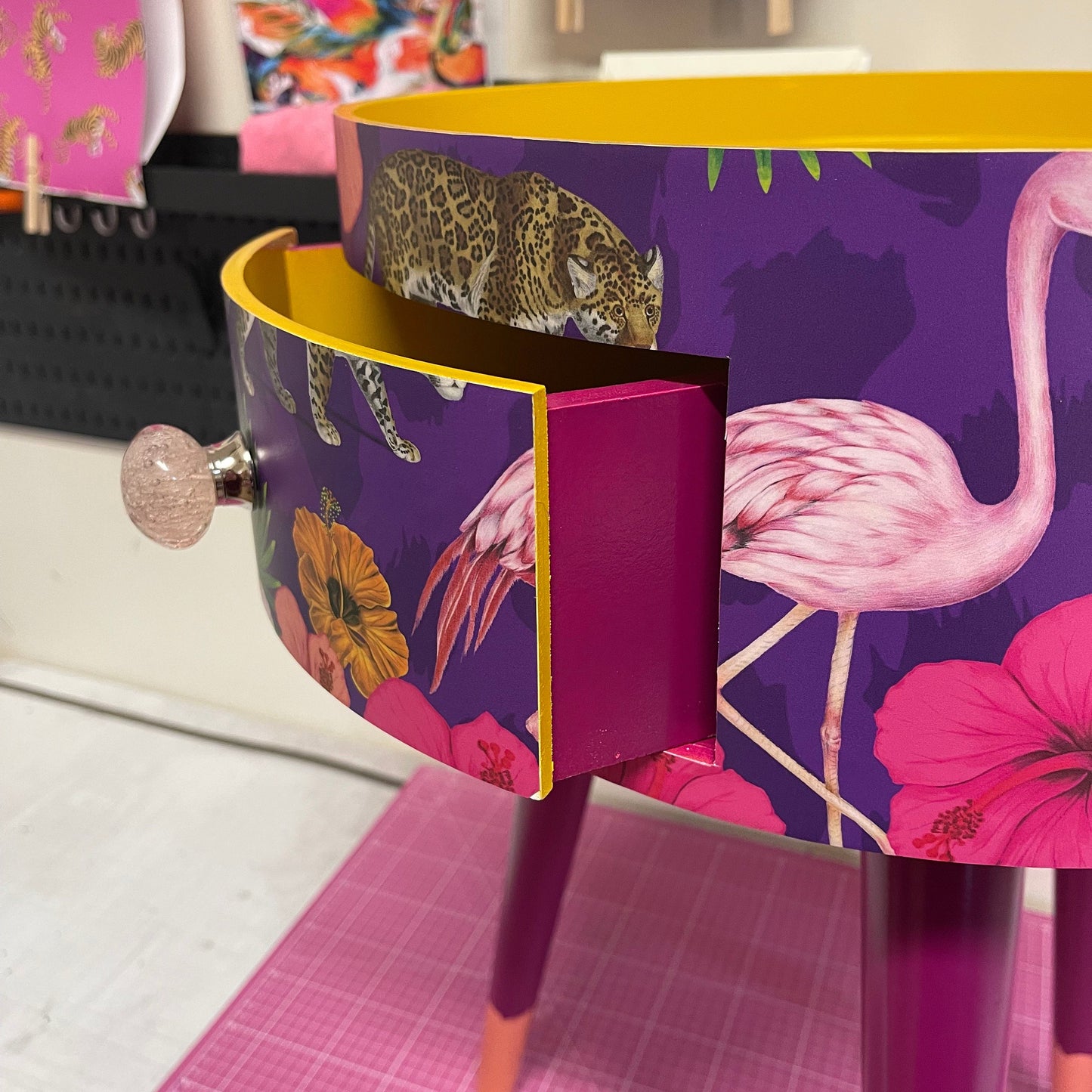 Flocking Fab - Purple side table. Round wooden table with drawer in purple yellow and pink tropical design. Personalised nightstand and side table.