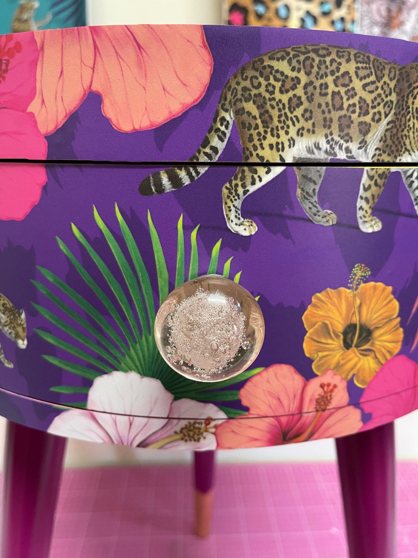 Flocking Fab - Purple side table. Round wooden table with drawer in purple yellow and pink tropical design. Personalised nightstand and side table.