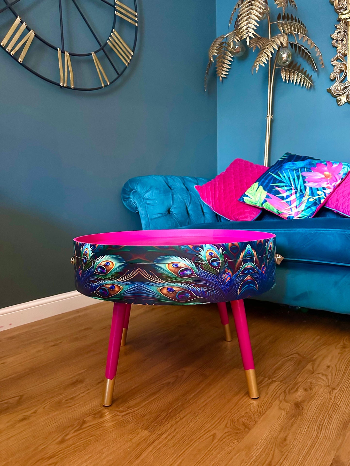 Round coffee table , peacock design, blue, teal and turquoise feathers. Bright pink. Round table, lift off top for storage. End table lounge