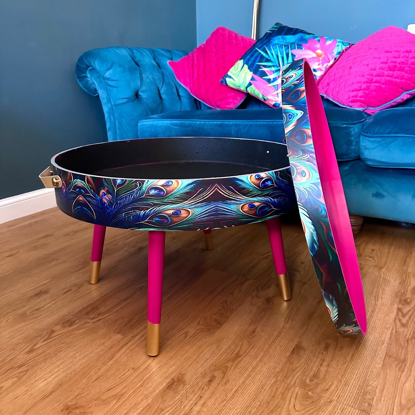 Round coffee table , peacock design, blue, teal and turquoise feathers. Bright pink. Round table, lift off top for storage. End table lounge