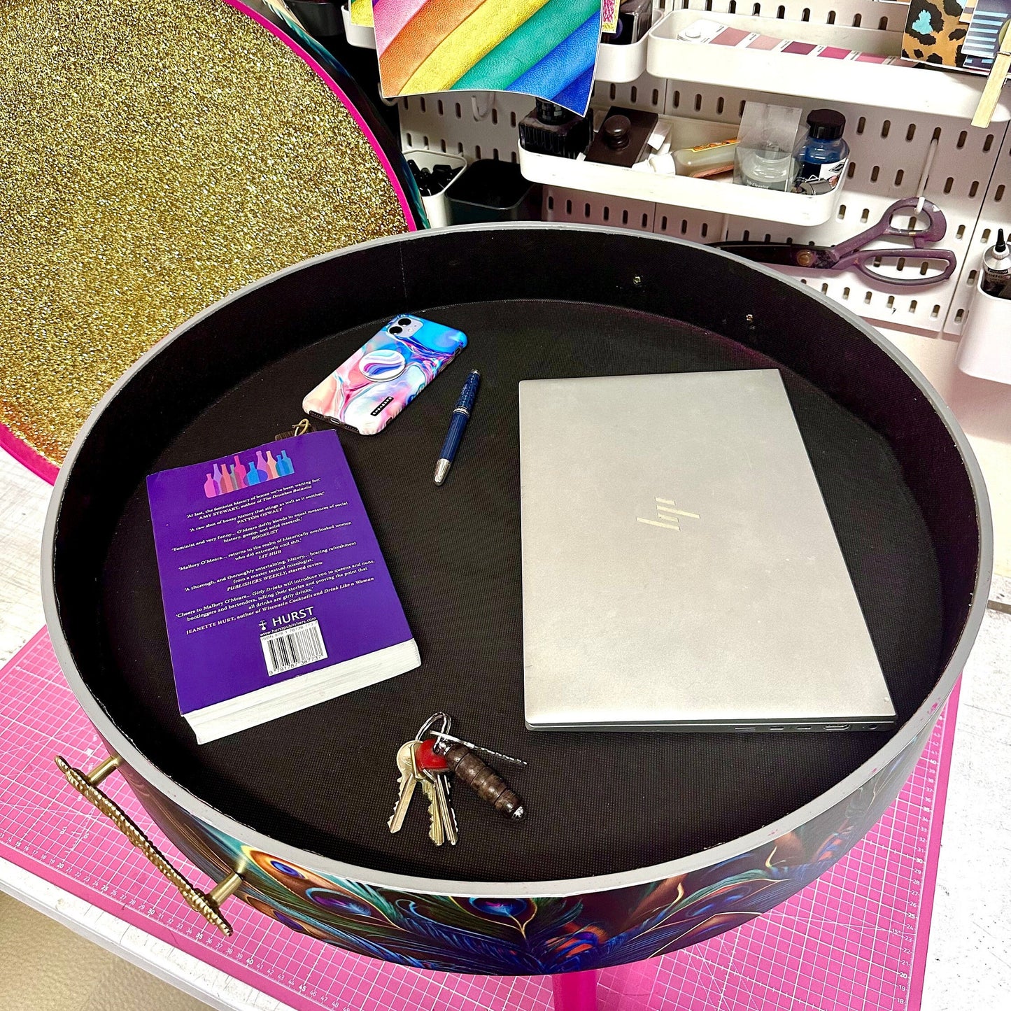 Round coffee table , peacock design, blue, teal and turquoise feathers. Bright pink. Round table, lift off top for storage. End table lounge