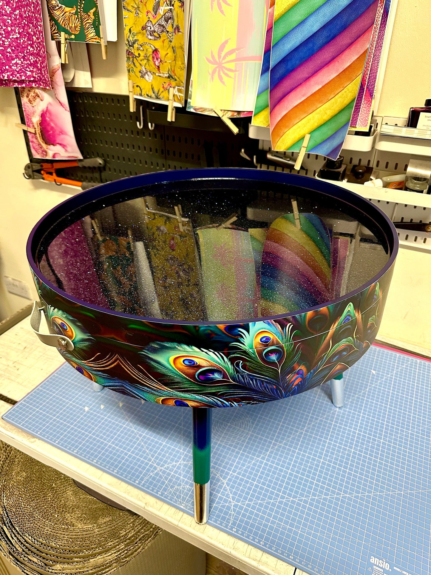 Round coffee table , peacock design, blue, teal  turquoise feathers. Navy Glitter . Round table, lift off top for storage. End table lounge