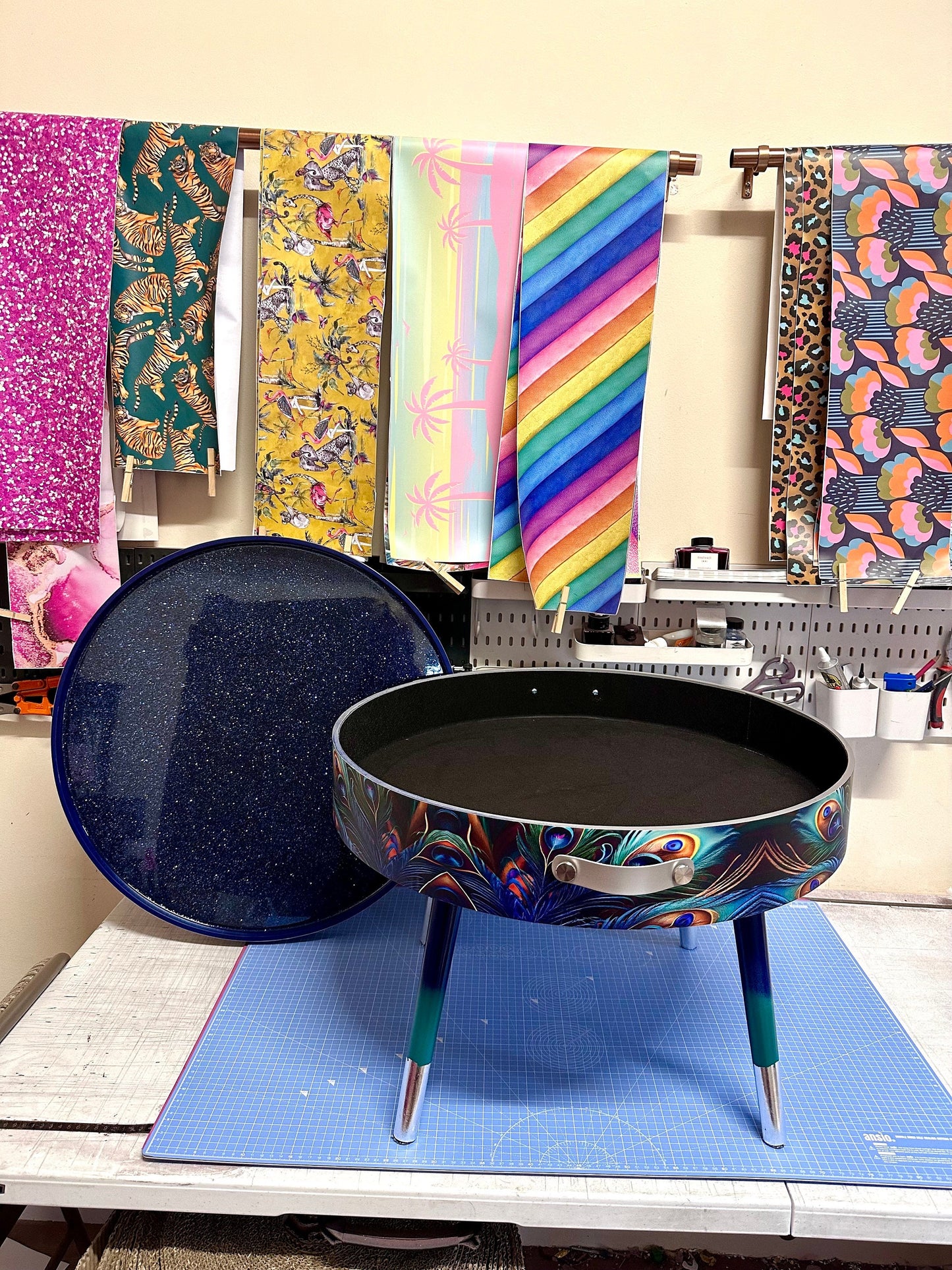 Round coffee table , peacock design, blue, teal  turquoise feathers. Navy Glitter . Round table, lift off top for storage. End table lounge