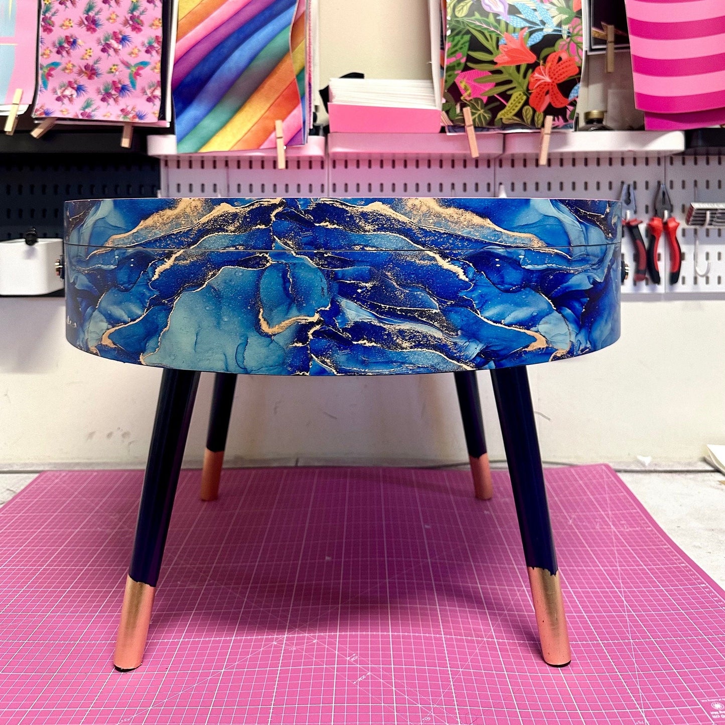 Round coffee table , blue and gold marble effect.  Navy blue and metallic effect. Hot pink, lift off top  storage. End table lounge