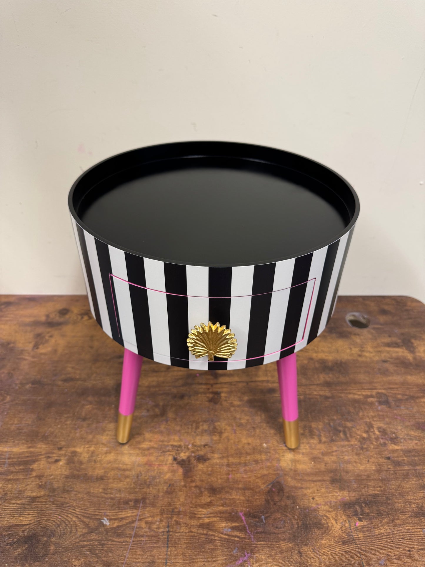 Striped table with pink legs
