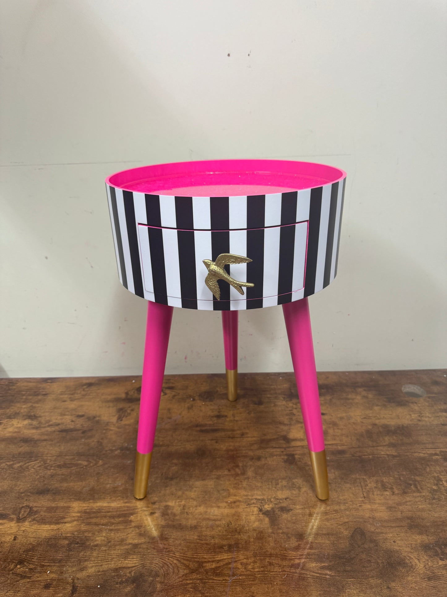 Black and white striped table with pink glitter top