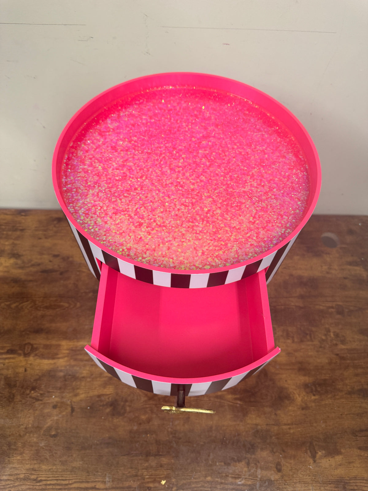 Black and white striped table with pink glitter top