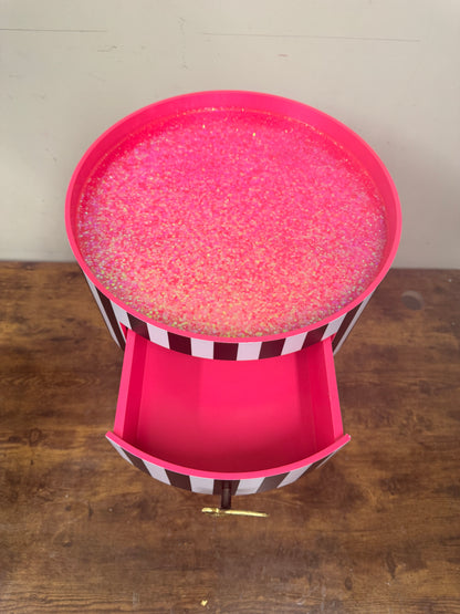 Black and white striped table with pink glitter top