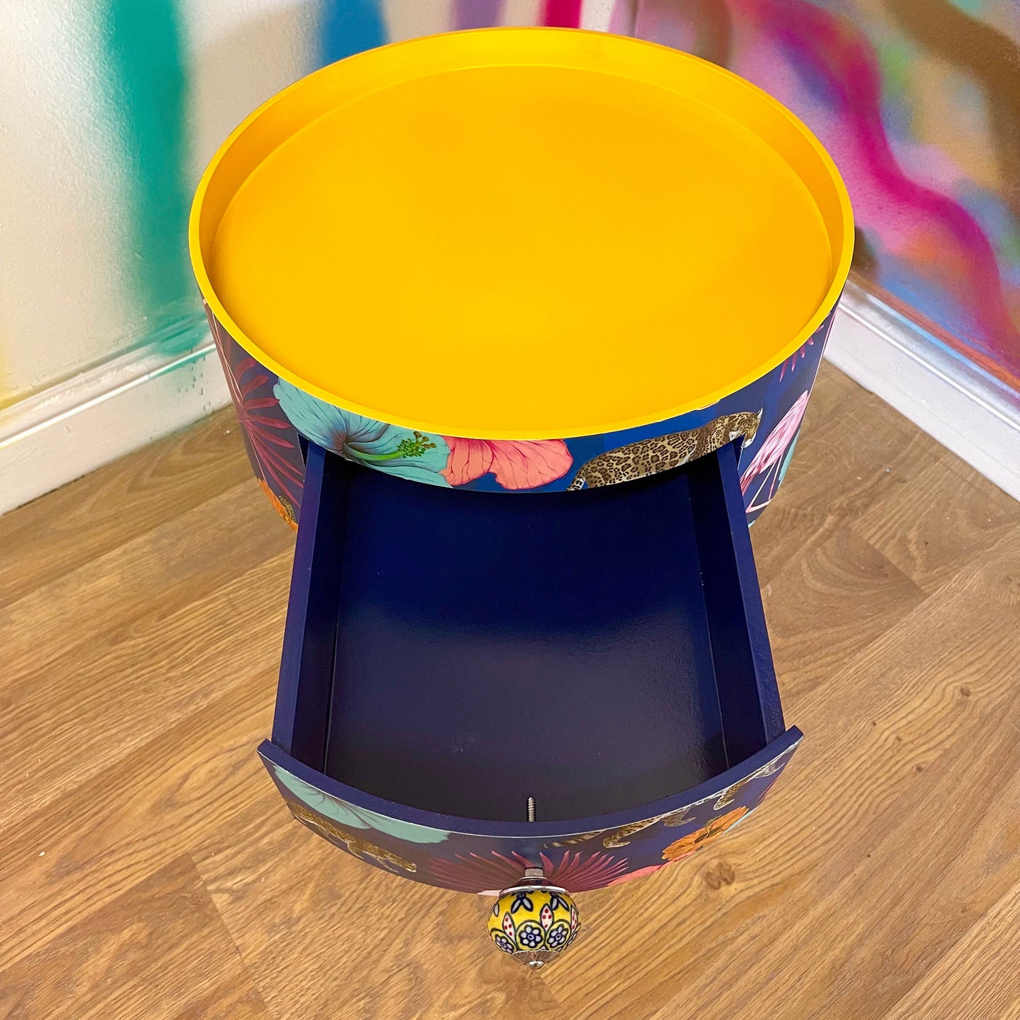Flocking Fab - Navy Round bedside table with drawer, navy and yellow nightstand with tropical and leopard design.  Blue side table with storage, eclectic table