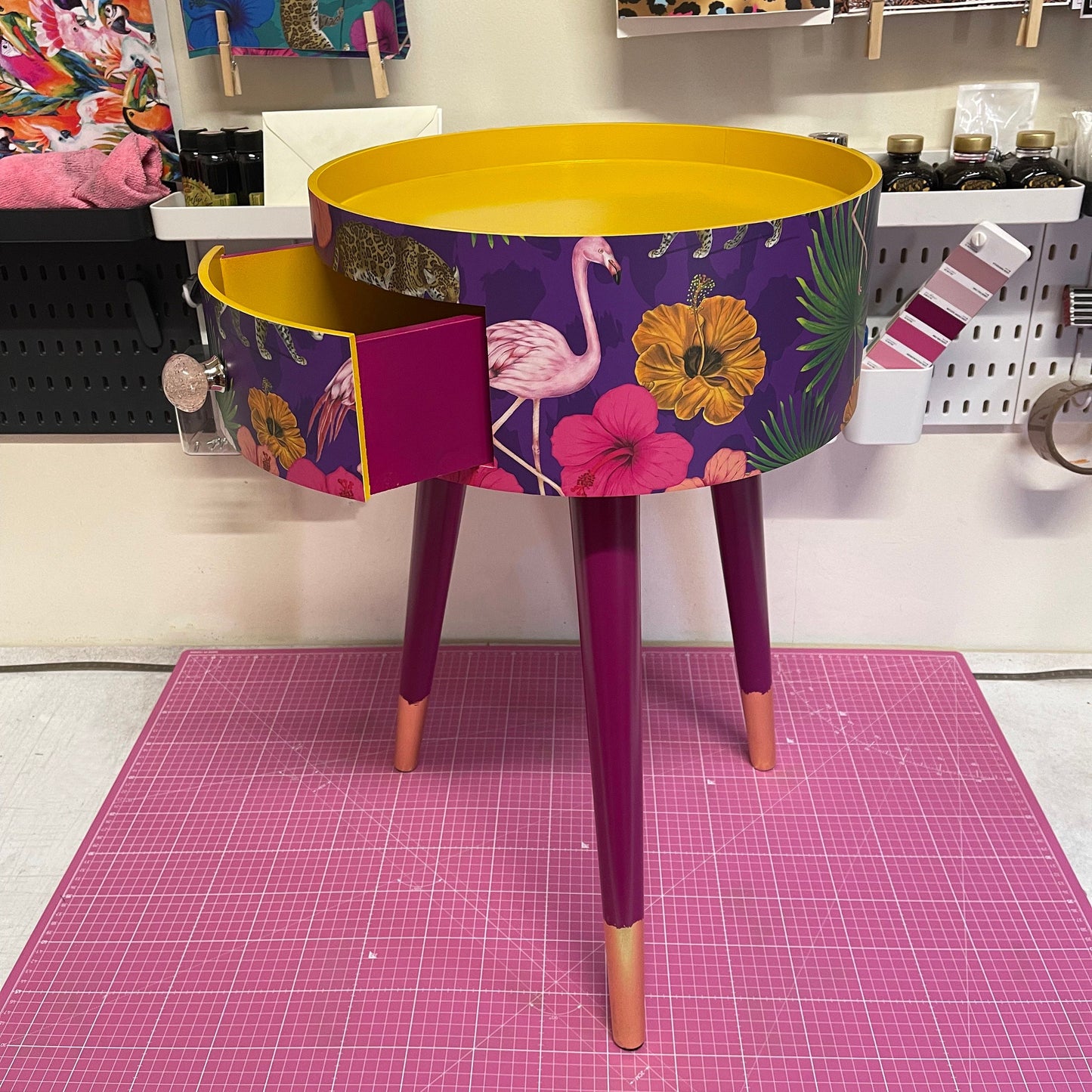 Flocking Fab - Purple side table. Round wooden table with drawer in purple yellow and pink tropical design. Personalised nightstand and side table.
