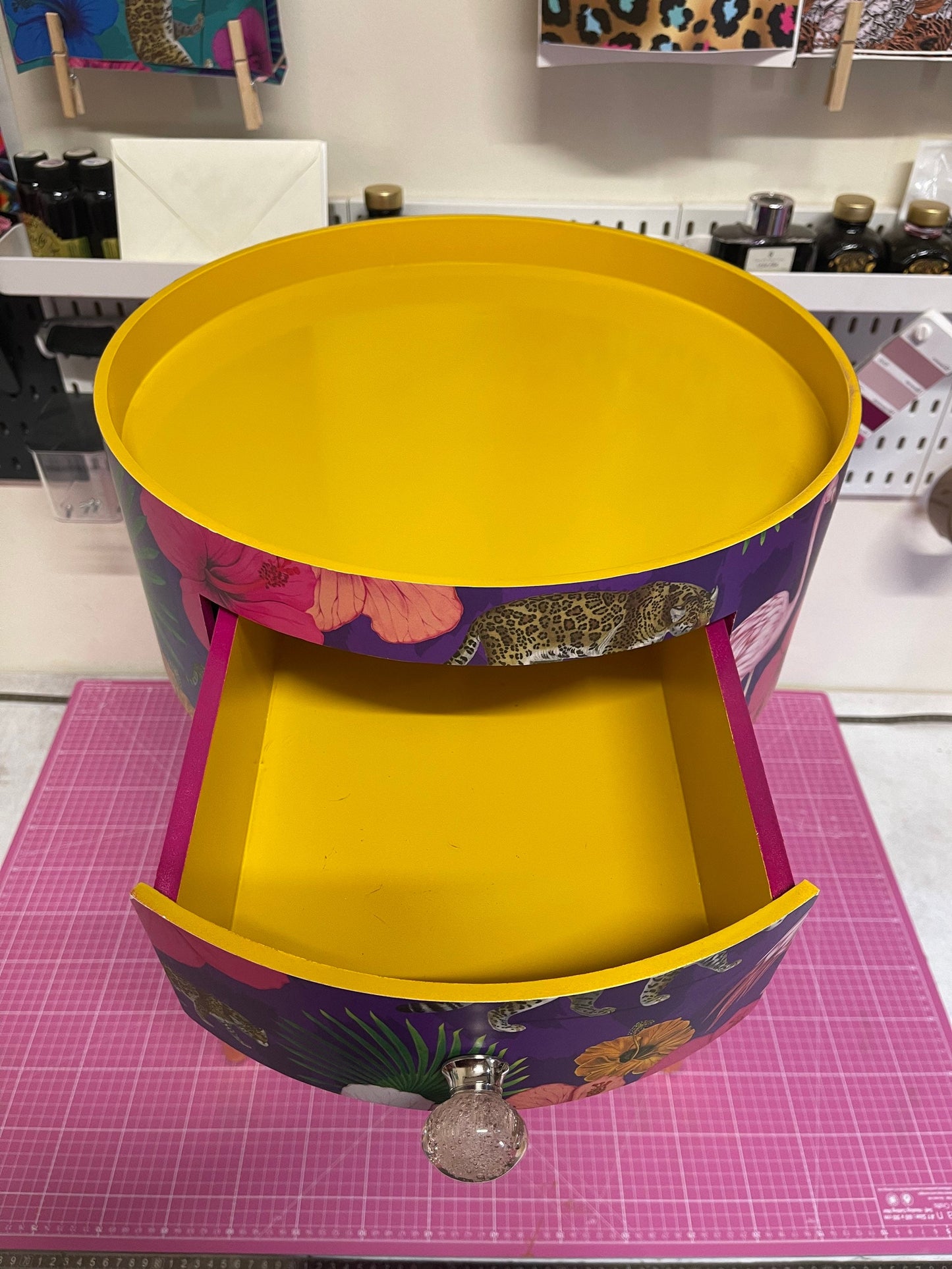 Flocking Fab - Purple side table. Round wooden table with drawer in purple yellow and pink tropical design. Personalised nightstand and side table.