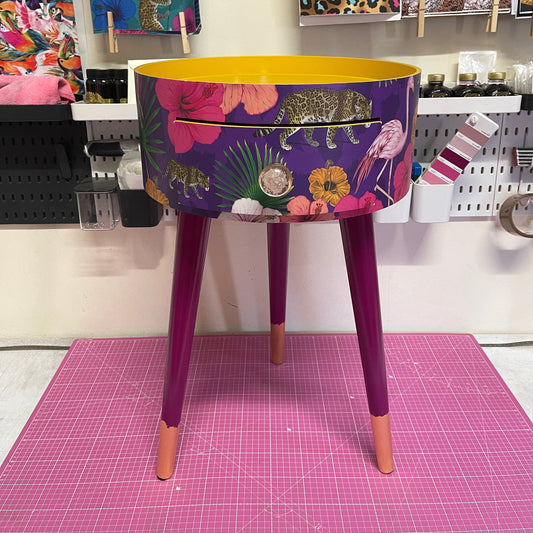 Flocking Fab - Purple side table. Round wooden table with drawer in purple yellow and pink tropical design. Personalised nightstand and side table.