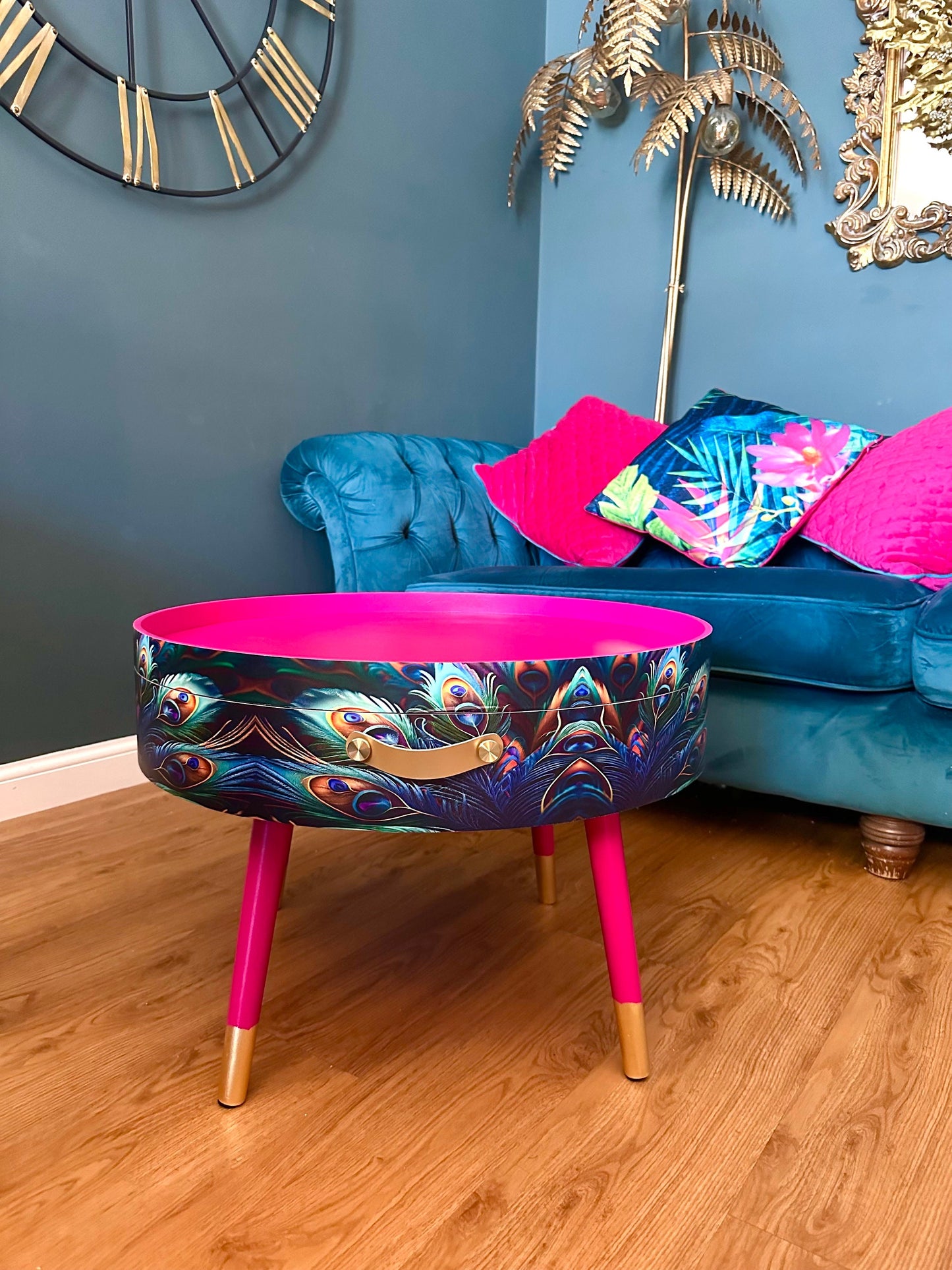 Round coffee table , peacock design, blue, teal and turquoise feathers. Bright pink. Round table, lift off top for storage. End table lounge