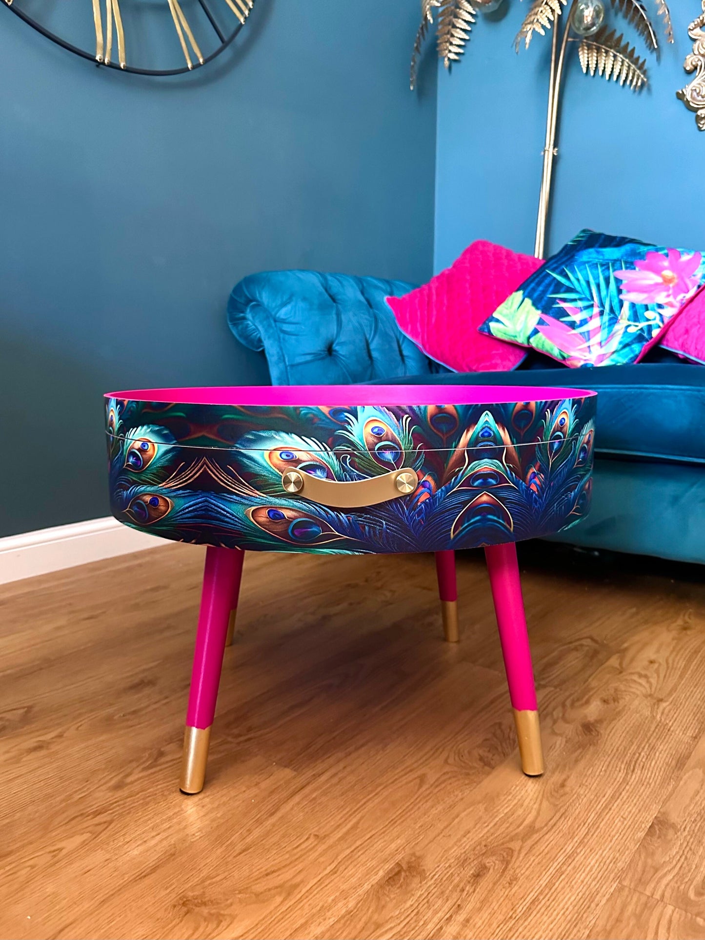 Round coffee table , peacock design, blue, teal and turquoise feathers. Bright pink. Round table, lift off top for storage. End table lounge