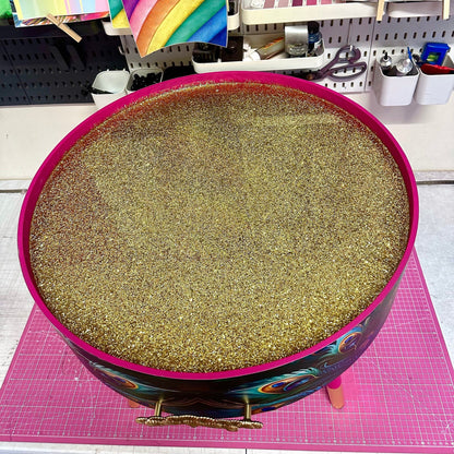 Round coffee table , peacock design, blue, teal and turquoise feathers. Bright pink. Round table, lift off top for storage. End table lounge