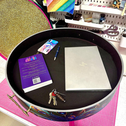 Round coffee table , peacock design, blue, teal and turquoise feathers. Bright pink. Round table, lift off top for storage. End table lounge