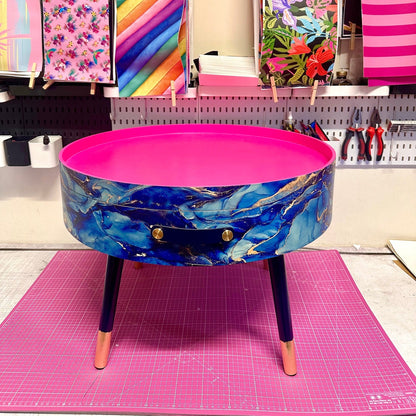 Round coffee table , blue and gold marble effect.  Navy blue and metallic effect. Hot pink, lift off top  storage. End table lounge
