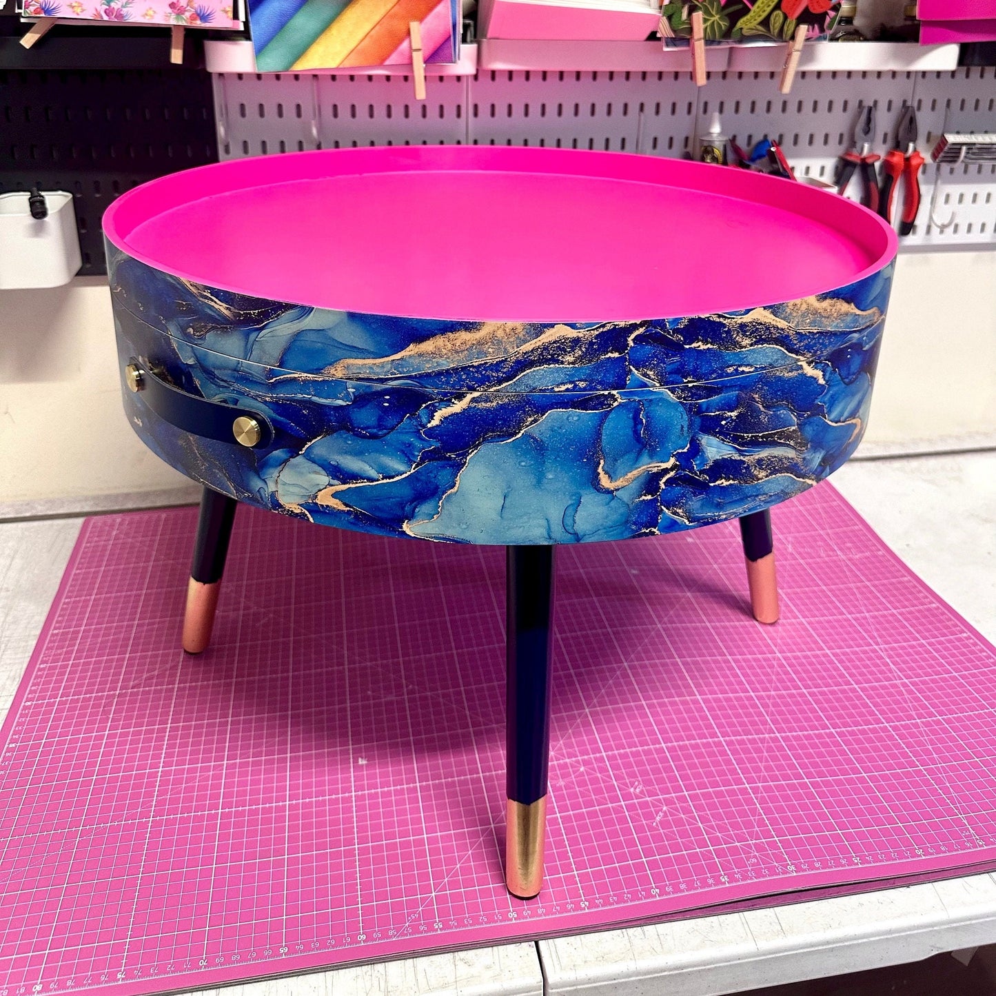 Round coffee table , blue and gold marble effect.  Navy blue and metallic effect. Hot pink, lift off top  storage. End table lounge