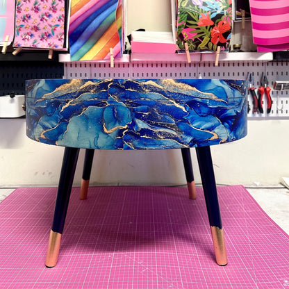 Round coffee table , blue and gold marble effect.  Navy blue and metallic effect. Hot pink, lift off top  storage. End table lounge