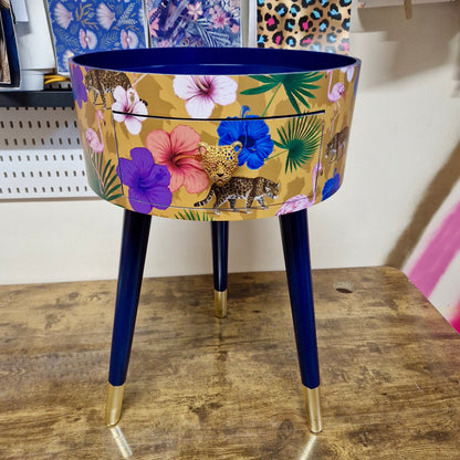 Flocking Fab - Yellow and navy round bedside table. Tropical design nightstand with flamingo and leopards. Cheetah and floral end table
