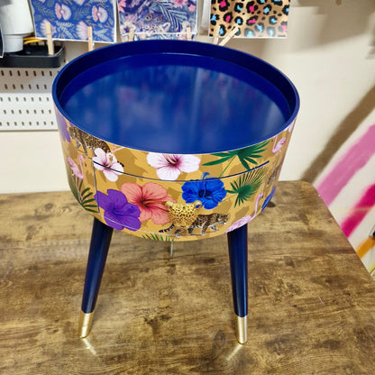 Flocking Fab - Yellow and navy round bedside table. Tropical design nightstand with flamingo and leopards. Cheetah and floral end table