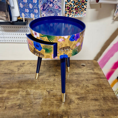 Flocking Fab - Yellow and navy round bedside table. Tropical design nightstand with flamingo and leopards. Cheetah and floral end table