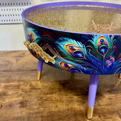 Round coffee table , peacock, blue, teal and turquoise feathers. Lilac purple gold glitter . Round table, storage, End table lounge