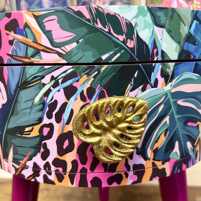 Leopard with Palm - Cherry blossom purple pink bedside table. Round wooden nightstand with leopard design in pinks, purples, greens. Cheetah end table with gold