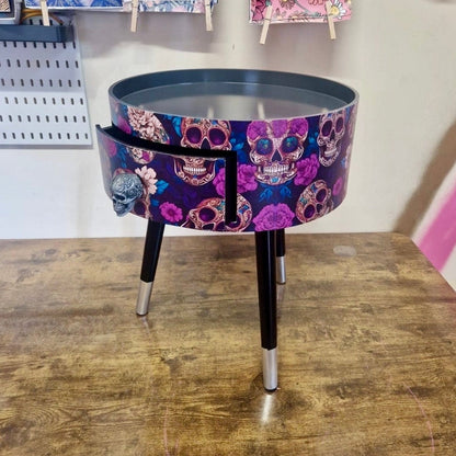 Skull design bedside table. Purple and black skull and roses, gothic inspired nightstand. Grey floral day of the dead end table